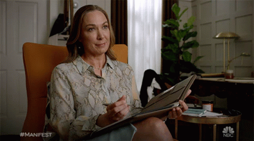 Woman Holding Folder With NBC Logo