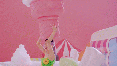 Woman Holding Giant Pink Ice Cream Cone on Head