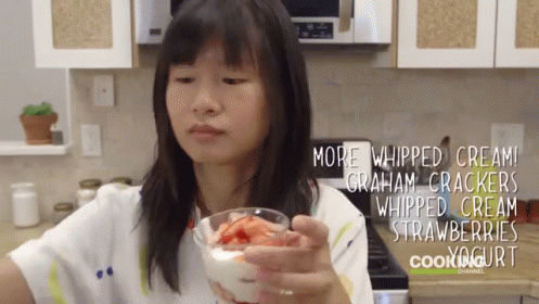 Woman Holding Glass Containing Berries And Cream GIF