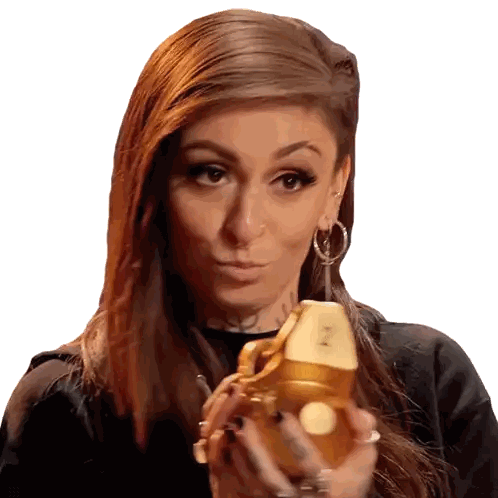 Woman Holding Gold Object With Letter N