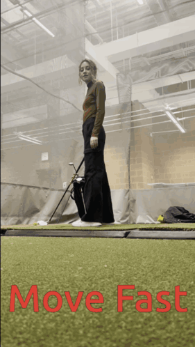 Woman Holding Golf Club in Gym