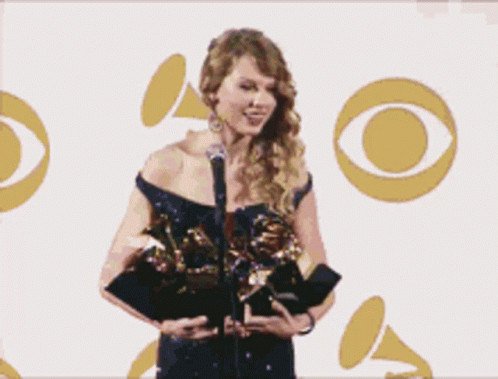 Woman Holding Grammy Award at Microphone