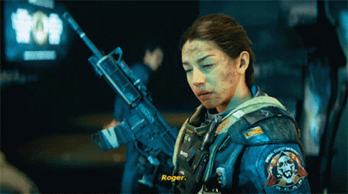 Woman Holding Gun With Roger On Sleeve GIF