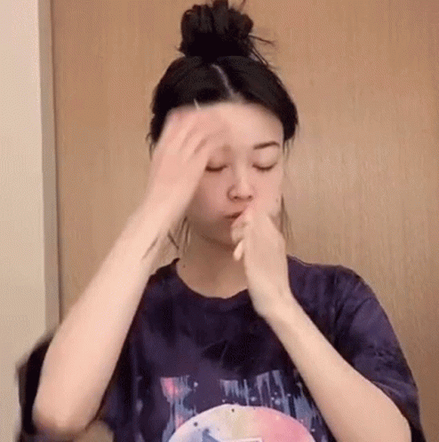 Woman Holding Hair Bun Applying Makeup GIF