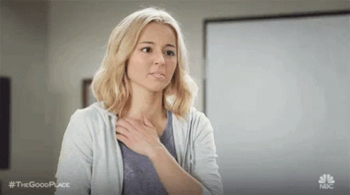 Woman Holding Hand to Chest
