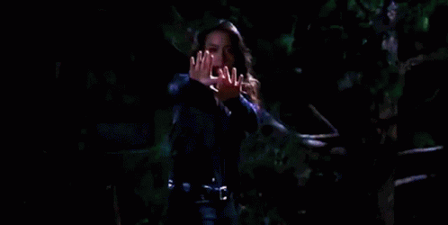 Woman Holding Hands Up In Darkness GIF