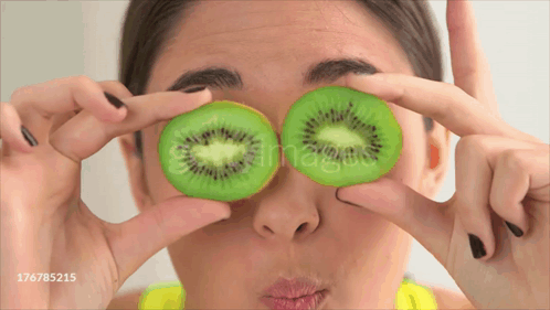 Woman Holding Kiwi Slices