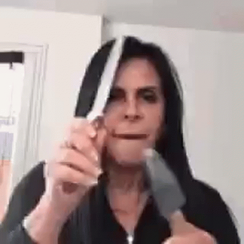 Woman Holding Knife Near Mouth