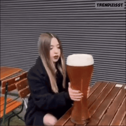 Woman Holding Large Glass of Beer
