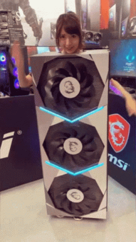 Woman Holding Large MSI Fan in Front of MSI Sign