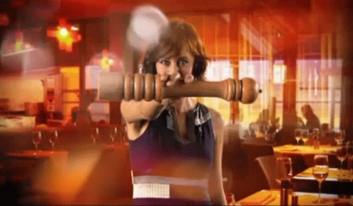 Woman Holding Large Pepper Mill