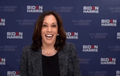 Woman Holding Leg in Front of Biden Harris Banner
