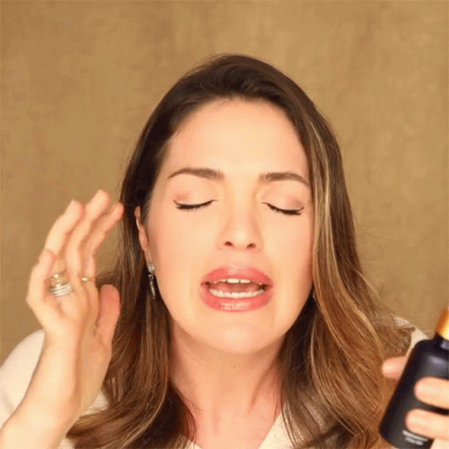 Woman Holding Lotion Bottle