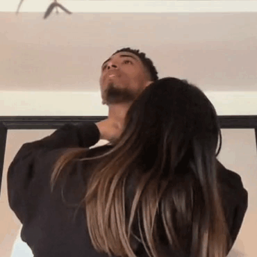Woman Holding Man's Neck Looking Up