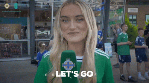 Woman Holding Microphone Saying Let's Go On It