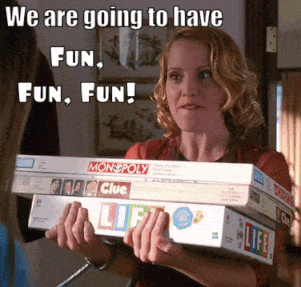 Woman Holding Monopoly And Clue Board Games GIF