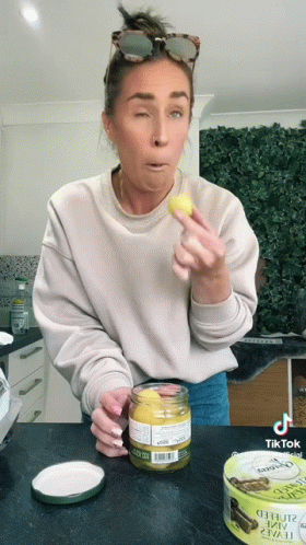Woman Holding Mustard Jar And Oyster Can GIF