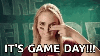 Woman Holding Nose in Front of Game Day Sign