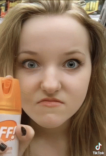 Woman Holding Off Bug Spray GIF