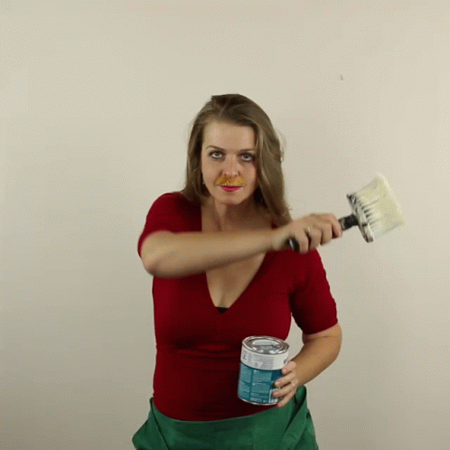 Woman Holding Paint Can and Brush
