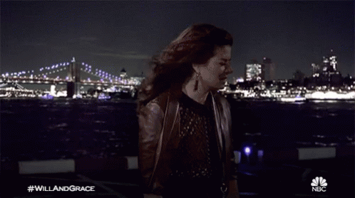 Woman Holding Paper in Front of Bridge #WillAndGrace