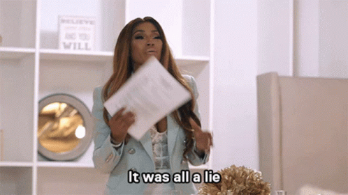 Woman Holding Paper Saying It Was All a Lie