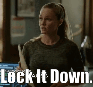 Woman Holding Paper Saying Lock It Down