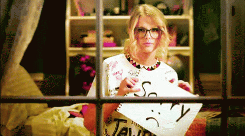 Woman Holding Paper With Sad Face and Word Taylor