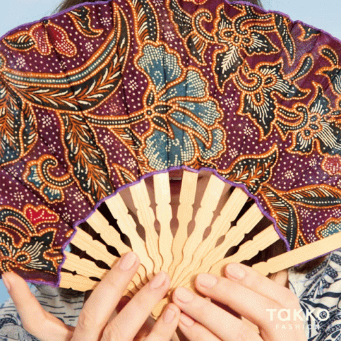 Woman Holding Patterned Fan