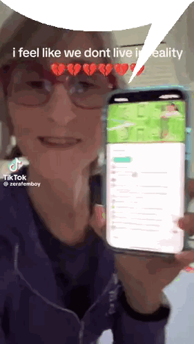 Woman Holding Phone Saying I Feel Like We Don t Live in Reality