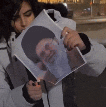 Woman Holding Picture of Bearded Man in Hat