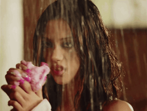 Woman Holding Pink Flower In Rain GIF