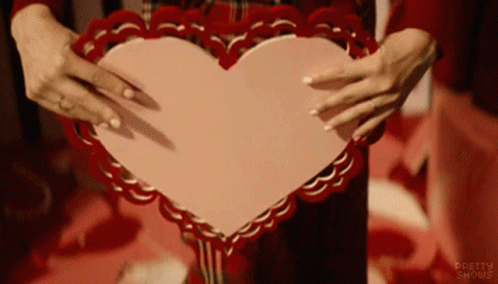 Woman Holding Pink Heart With Pretty Shows