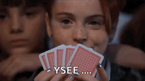 Woman Holding Playing Cards Saying Ysee