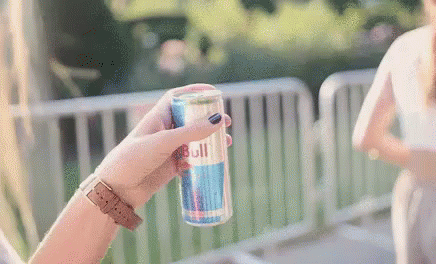 Woman Holding Red Bull Can