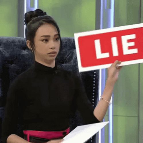 Woman Holding Red Lie Sign