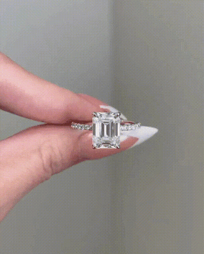 Woman Holding Ring With Large Diamond