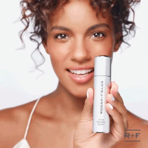 Woman Holding Rodan Fields Hydration Serum GIF