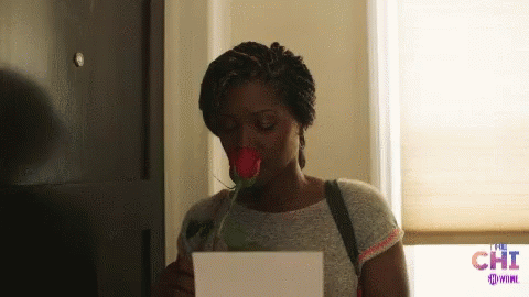 Woman Holding Rose and Paper Saying Chi