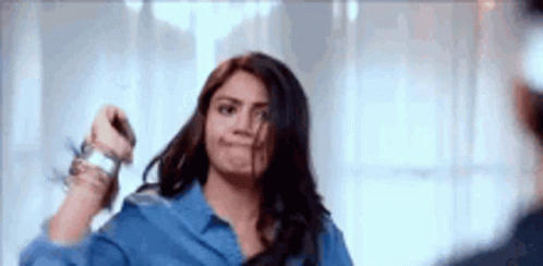Woman Holding Scissors In Front Of Mirror GIF
