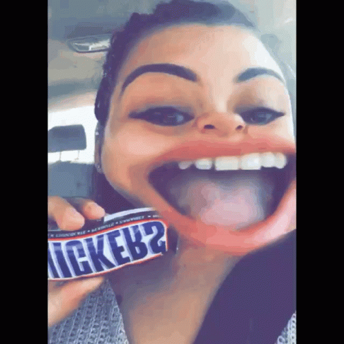 Woman Holding Snickers Bar