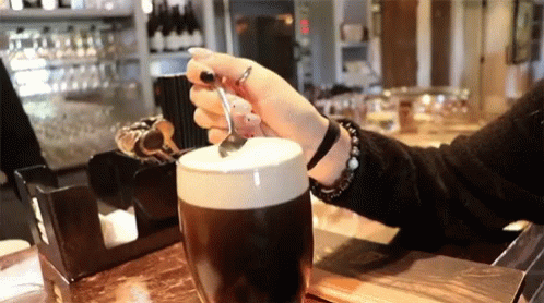 Woman Holding Spoon Over Coffee GIF