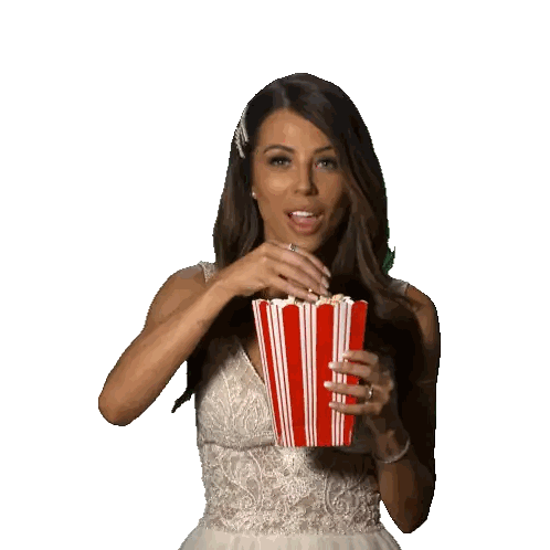 Woman Holding Striped Popcorn Container
