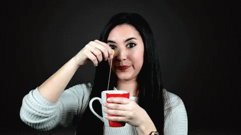 Woman Holding Tea Cup Pouring GIF