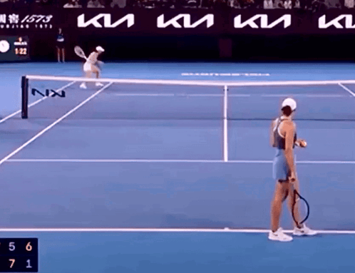 Woman Holding Tennis Racquet on Court With KTM Ad