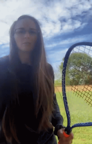 Woman Holding Tennis Racquet Saying Head