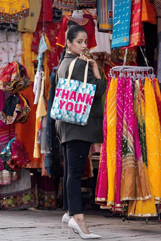 Woman Holding Thank You Bag in Front of Store