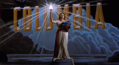 Woman Holding Torch in Front of Columbia Logo