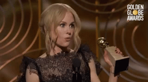 Woman Holding Trophy Talking Into Microphone Golden Globes Awards