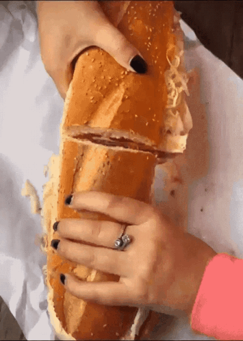 Woman Holding Very Long Sandwich With Ring